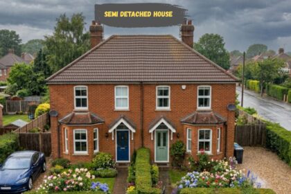 Semi-detached brick house with front garden and driveway.