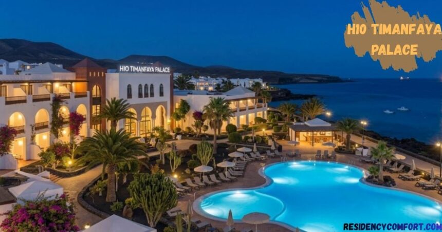 H10 Timanfaya Palace luxury resort at dusk with illuminated outdoor pools, elegant white architecture, palm trees, landscaped gardens, and scenic oceanfront views in Lanzarote.