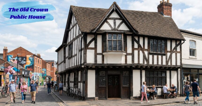 Historic The Old Crown Public House, a timber-framed Tudor-style building on a lively street with pedestrians, outdoor seating, and colorful murals in the background.