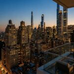 Apartment skyline at sunset featuring a luxury balcony overlooking illuminated high-rise buildings, modern skyscrapers, and the vibrant city skyline with expansive urban views.