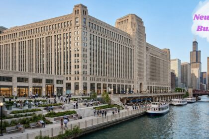 New Mart Building along the Chicago River with boats, a riverside walkway, and the city skyline.