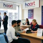 Haart estate agents office with staff assisting clients and discussing property services.