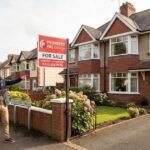 Property Pal Omagh for sale sign outside a residential house in Omagh with buyers viewing the property.
