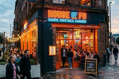 House of Fu ramen restaurant in Manchester city center with vibrant neon signage and outdoor seating.
