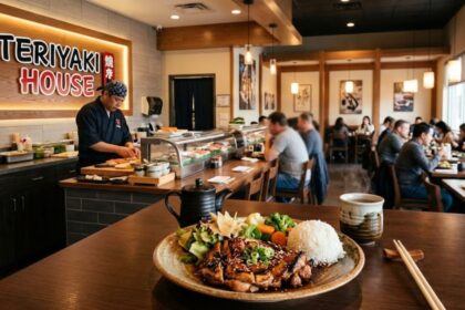 Teriyaki House restaurant interior with chef preparing a Japanese meal and a plated teriyaki chicken dish in the foreground.